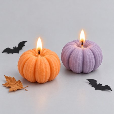 Bougies citrouilles orange et lilas allumées avec feuilles et chauves-souris décoratives