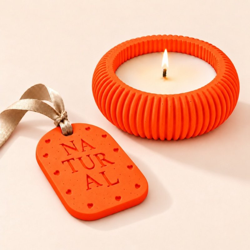 Portavelas y placa aromática de escayola en naranja neón con cinta beige